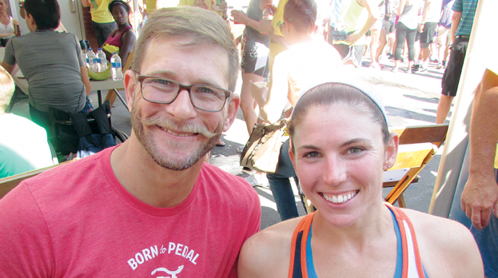 Amanda McCrory and her friend, Adam Finney, relax after McCrory won the Boilermaker’s women’s wheelchair division title for the fifth consecutive year and sixth time overall.