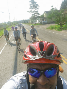 Mark Montgomery, organizer and founder of Joseph’s Experience, takes a “selfie” with his cell phone camera showing the pack of bicyclists who participated in the 15-mile “Joe’s Ride” recently.
