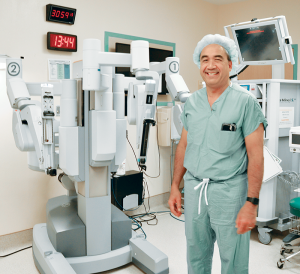 MVHS Medical Director for Robotic Surgery Jonathan Blancaflor, MD, FACS, stands beside the da Vinci® Si™ Surgical System at the St. Elizabeth Campus.