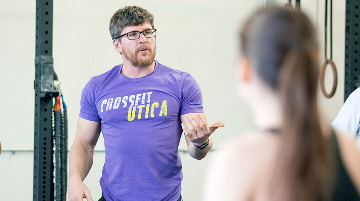 Anthony Mucurio, left, owner and head coach of CrossFit Utica, takes charge during a recent training session.
