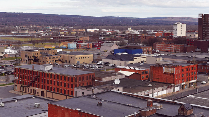 This photo, courtesy of the Observer-Dispatch, shows the location in downtown Utica for the proposed Mohawk Valley Health System hospital. Looking east toward the Doubletree by Hilton Hotel Utica, the tall brick building at upper right, and the Adirondack Bank Center at the Utica Memorial Auditorium (round, white building at left), the campus will cover approximately 25 acres and include State, Lafayette, Cornelia and Columbia streets, along with Broadway.