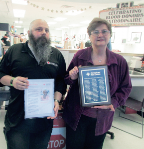 Mike Brunet holds a copy of a “Story of Hope,” a cancer patient who has been helped by a donation of platelets. Mary Brunet holds a copy of the plaque with the names of this year’s major platelet donors — those who gave 24 times. The Brunets were among a select group of about 60 donors who were honored recently by the Mohawk Valley chapter of the American Red Cross for making the maximum amount of donations within a 12-month period.