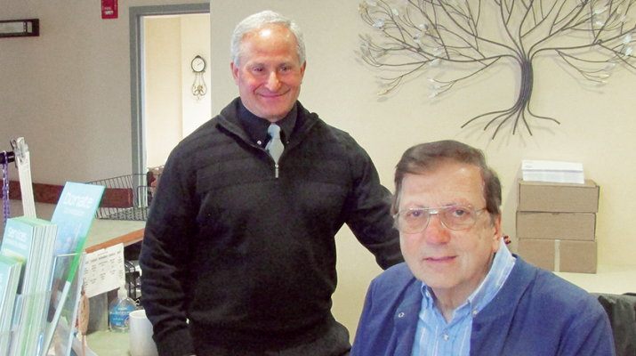 Anthony Fragapane, left, who was recently named spiritual care coordinator at Hospice & Palliative Care in New Hartford, chats with long-time employee and The Siegenthaler Center’s receptionist Frank Calaprice.