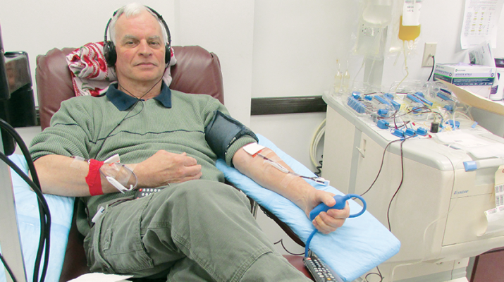 Tom O’Hara watches a video and listens to music while giving a donation of platelets at the Mohawk Valley Red Cross office in New Hartford. The process takes between two to three hours.