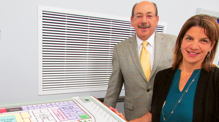 Alicia Dicks, president and CEO of The Community Foundation, and Rudy D’Amico, president and CEO of the Central Association for the Blind and Visually Impaired, look over plans for the new rehabilitation center.