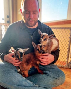 Craig T. Brown, 4-H youth development resource educator, Cornell Cooperative Extension, Madison County, holds 3-week-old Nigerian Dwarf dairy goats recently during recent program activity.
