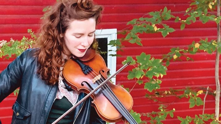 Nora Revenaugh, a board member at the Kirkland Art Center, takes pleasure in playing the violin.