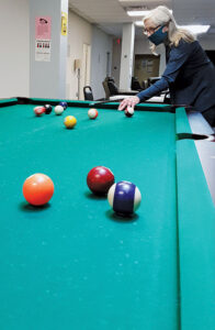 Rise RCOC has a pool table, fuseball, meditation room, craft room and ping pong table, among other recreational activities, for its members. Pictured above is peer advocate Jean Verri.